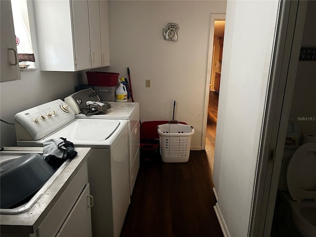 2065 Flamingo Dr, Bartow, FL 33830 - laundry area with washer and clothes dryer, dark wood finished floors, and cabinet space