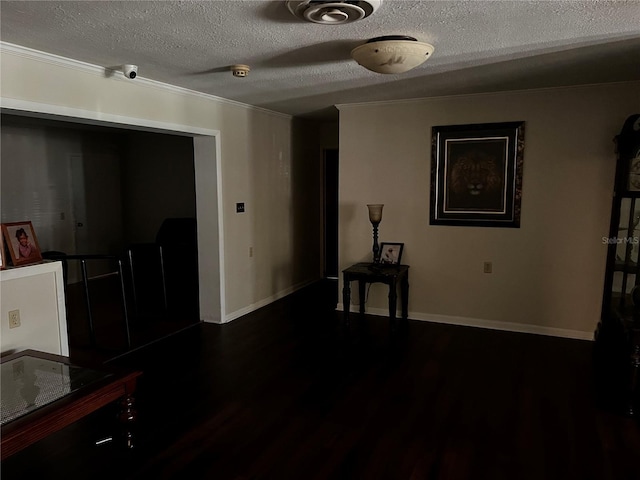 2065 Flamingo Dr, Bartow, FL 33830 - empty room featuring a textured ceiling, dark wood-type flooring, a smoke detector, and ornamental molding