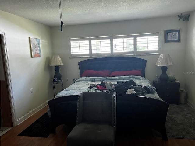 2065 Flamingo Dr, Bartow, FL 33830 - bedroom with wood finished floors, multiple windows, and a textured ceiling