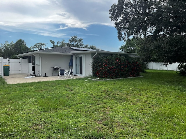 2065 Flamingo Dr, Bartow, FL 33830 - rear view of house featuring stucco siding, a gate, a patio area, and a fenced backyard