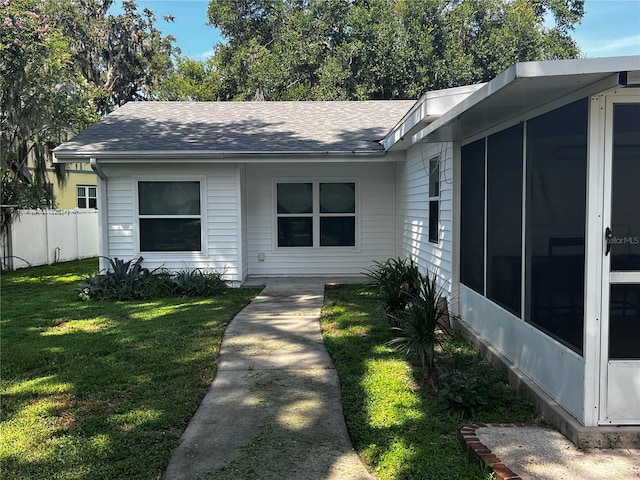 2065 Flamingo Dr, Bartow, FL 33830 - view of front facade with roof with shingles and a sunroom