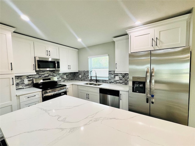 7013 Symmes Rd, Gibsonton, FL 33534 - kitchen with stainless steel appliances, tasteful backsplash, white cabinetry, and recessed lighting