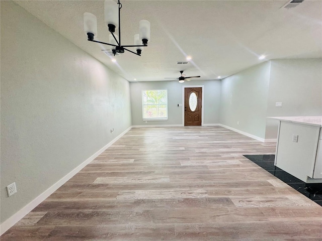 7013 Symmes Rd, Gibsonton, FL 33534 - unfurnished living room with a chandelier, wood finished floors, and a ceiling fan