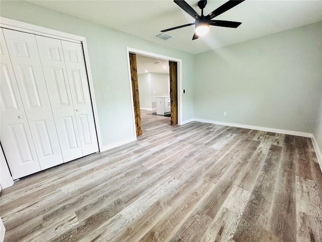 7013 Symmes Rd, Gibsonton, FL 33534 - unfurnished bedroom with light wood-style flooring, a closet, and ceiling fan