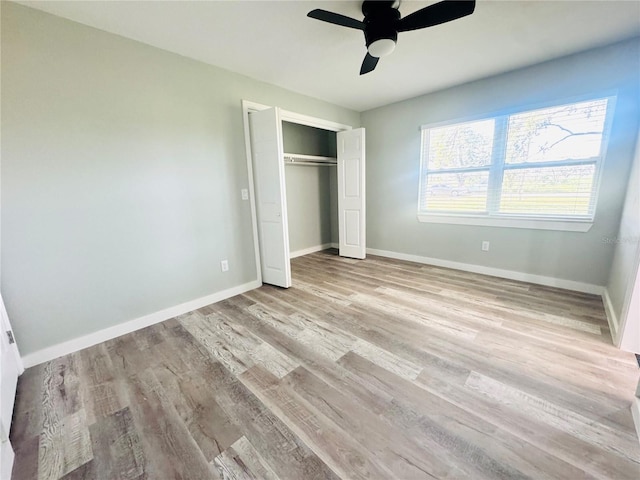 7013 Symmes Rd, Gibsonton, FL 33534 - unfurnished bedroom with wood finished floors, a closet, and ceiling fan