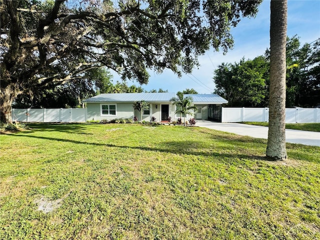 7013 Symmes Rd, Gibsonton, FL 33534 - single story home with an attached carport, driveway, and a metal roof