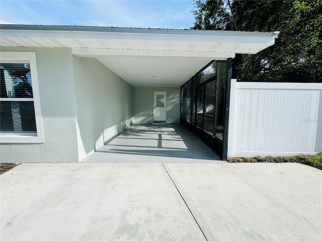7013 Symmes Rd, Gibsonton, FL 33534 - view of exterior entry featuring an attached carport, stucco siding, and driveway