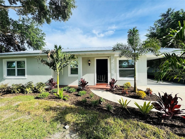 7013 Symmes Rd, Gibsonton, FL 33534 - ranch-style home with stucco siding, driveway, and a carport