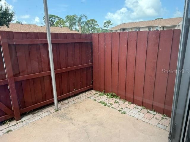 2763 Woodgate Ln Unit 111, Sarasota, FL 34231 - gate featuring a patio area