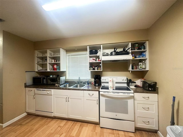 4007 7th St E, Bradenton, FL 34208 - kitchen with open shelves, white appliances, light wood finished floors, and dark countertops