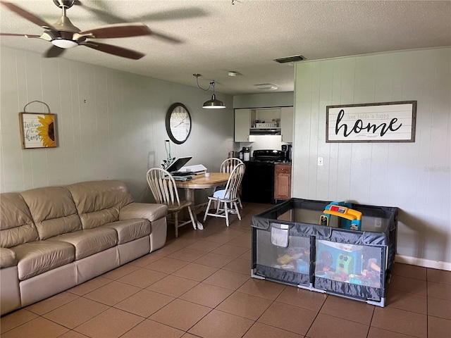 4007 7th St E, Bradenton, FL 34208 - tiled living room with ceiling fan and a textured ceiling