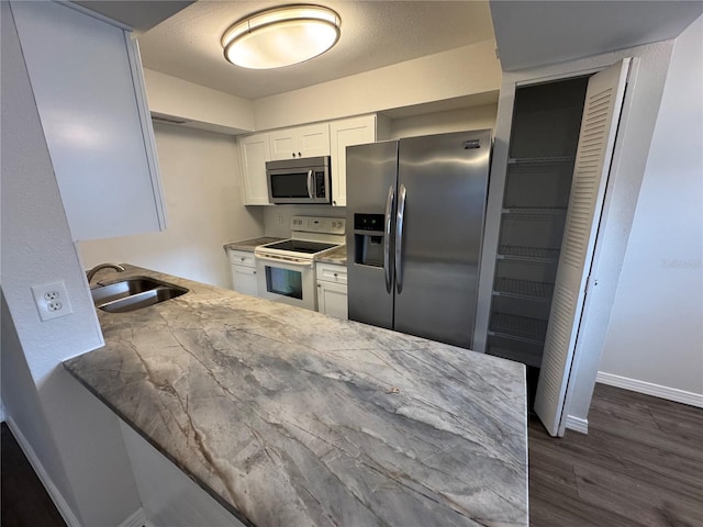 4503 3rd Street Cir W Unit 266, Bradenton, FL 34207 - kitchen with appliances with stainless steel finishes, dark wood-type flooring, and white cabinets
