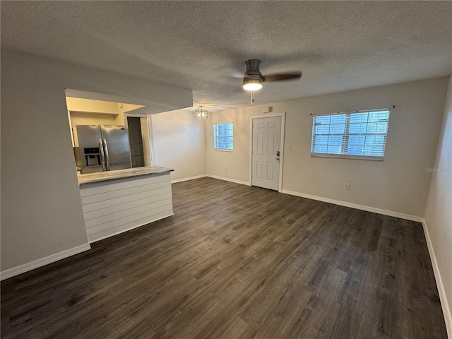 4503 3rd Street Cir W Unit 266, Bradenton, FL 34207 - unfurnished living room featuring a ceiling fan, healthy amount of natural light, dark wood finished floors, and a textured ceiling