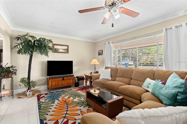 2108 Outer Dr, Sarasota, FL 34231 - living room featuring a textured ceiling, tile patterned floors, a ceiling fan, and ornamental molding
