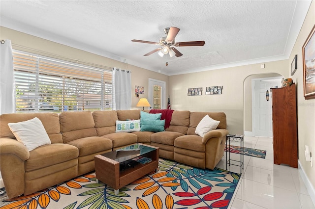 2108 Outer Dr, Sarasota, FL 34231 - living room featuring arched walkways, a ceiling fan, light tile patterned floors, and a textured ceiling