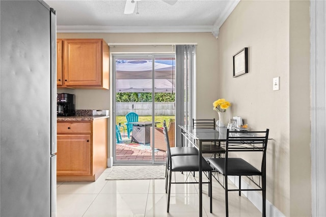 2108 Outer Dr, Sarasota, FL 34231 - dining area with ornamental molding, ceiling fan, and light tile patterned floors