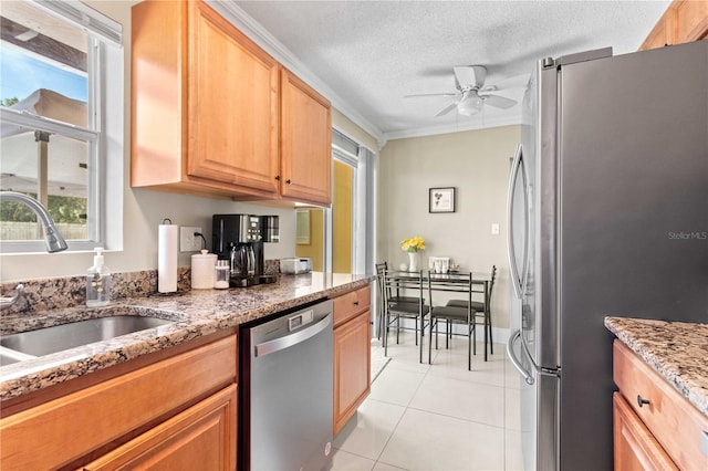 2108 Outer Dr, Sarasota, FL 34231 - kitchen with stainless steel appliances, ceiling fan, light tile patterned floors, healthy amount of natural light, and a textured ceiling