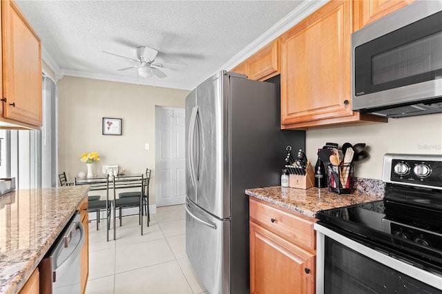 2108 Outer Dr, Sarasota, FL 34231 - kitchen featuring appliances with stainless steel finishes, ceiling fan, light stone counters, light tile patterned floors, and a textured ceiling