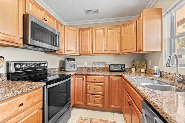 2108 Outer Dr, Sarasota, FL 34231 - kitchen with appliances with stainless steel finishes, light tile patterned floors, light stone countertops, ornamental molding, and a textured ceiling