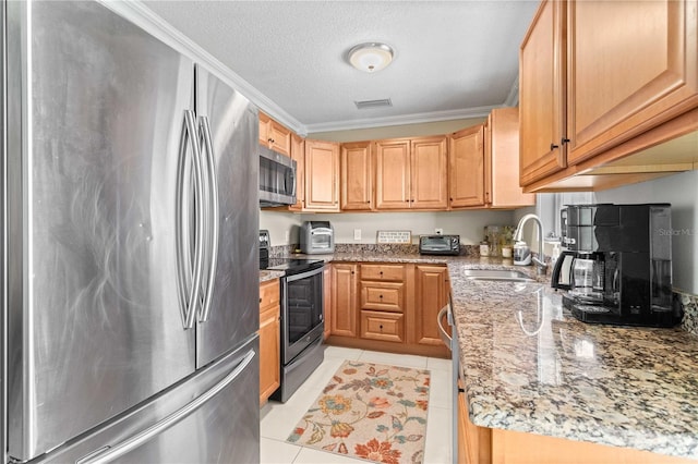 2108 Outer Dr, Sarasota, FL 34231 - kitchen with stainless steel appliances, light stone countertops, crown molding, light tile patterned flooring, and a textured ceiling