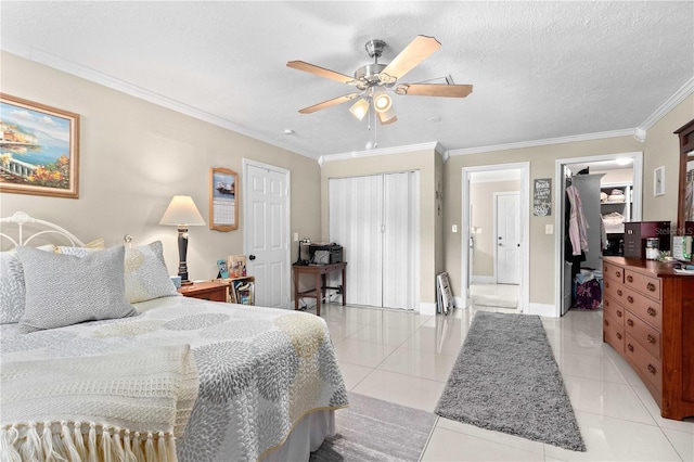 2108 Outer Dr, Sarasota, FL 34231 - bedroom featuring light tile patterned floors, ornamental molding, ceiling fan, and multiple closets