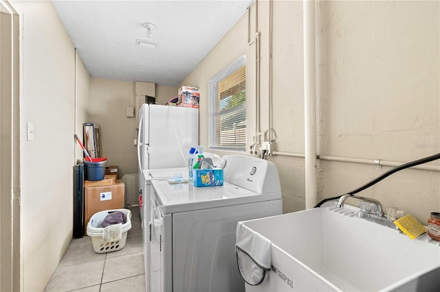 2108 Outer Dr, Sarasota, FL 34231 - laundry room with washer and clothes dryer and light tile patterned flooring