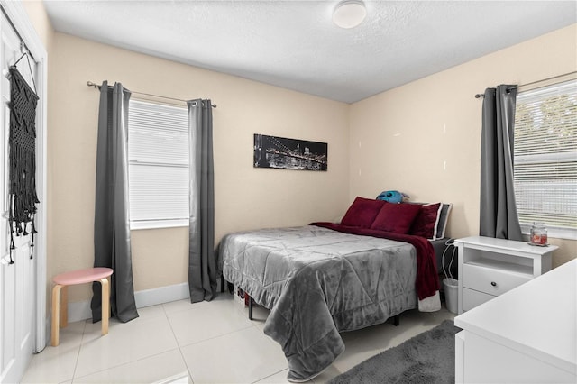 2108 Outer Dr, Sarasota, FL 34231 - bedroom featuring light tile patterned floors and a textured ceiling