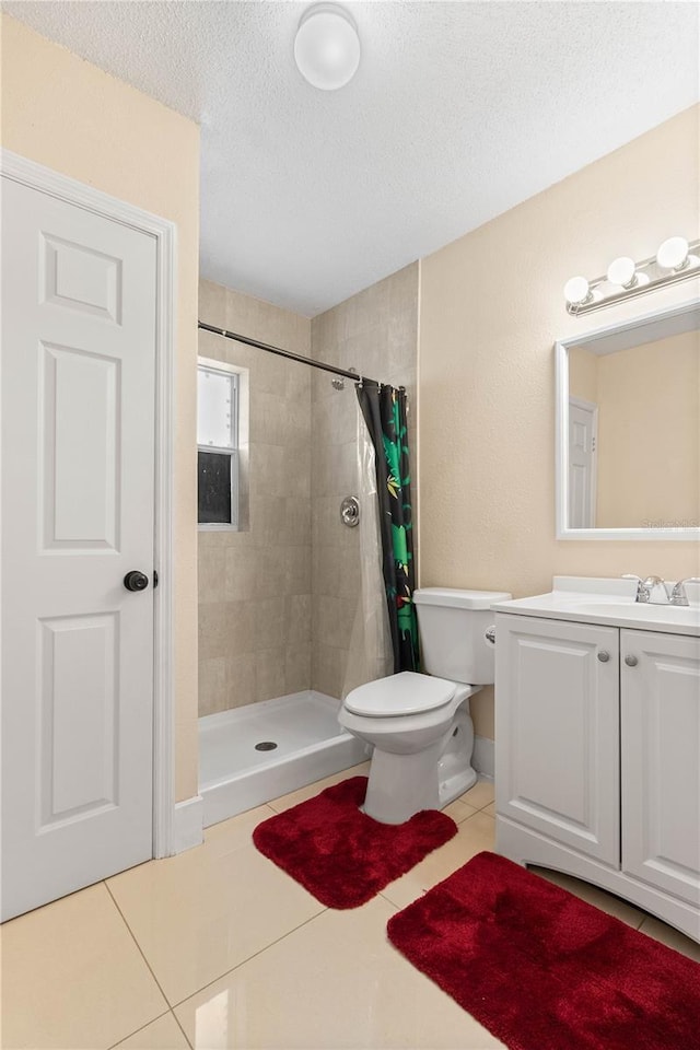 2108 Outer Dr, Sarasota, FL 34231 - full bath featuring a tile shower, vanity, tile patterned flooring, and a textured ceiling