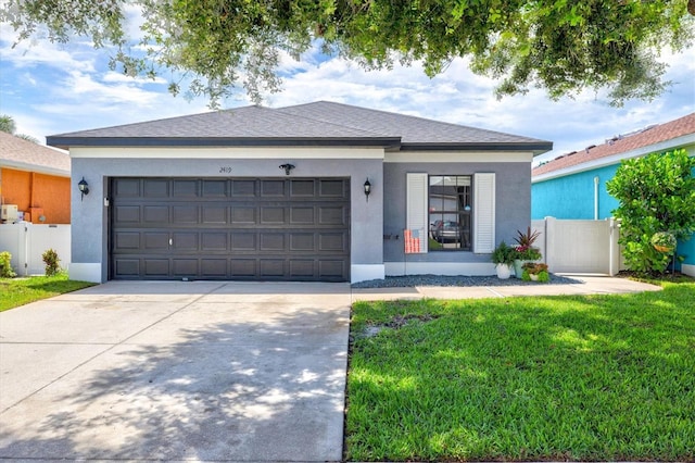 2419 29th Ave E, Palmetto, FL 34221 - view of front of property with driveway, an attached garage, stucco siding, and a shingled roof
