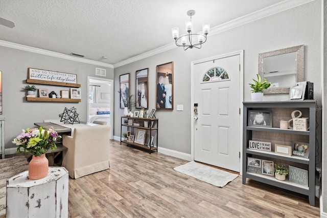2419 29th Ave E, Palmetto, FL 34221 - foyer entrance featuring a chandelier, wood finished floors, ornamental molding, and a textured ceiling