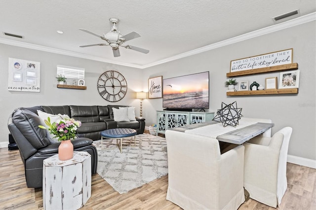 2419 29th Ave E, Palmetto, FL 34221 - living area with crown molding, a ceiling fan, wood finished floors, and a textured ceiling