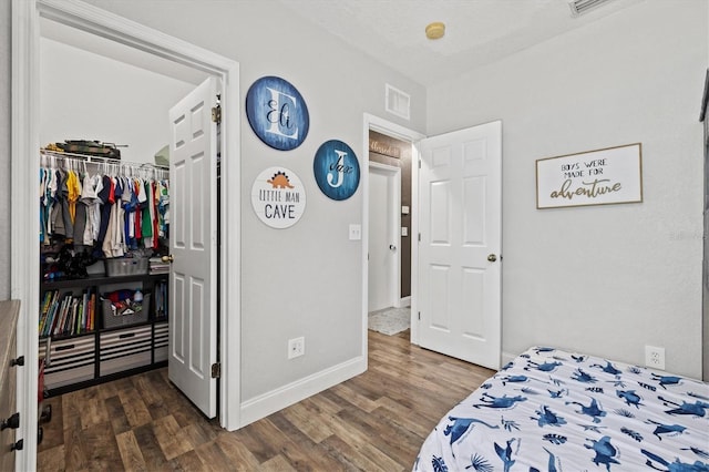 2419 29th Ave E, Palmetto, FL 34221 - bedroom with dark wood-style floors and a spacious closet
