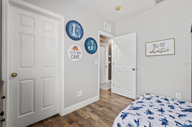2419 29th Ave E, Palmetto, FL 34221 - bedroom with baseboards and dark wood-style flooring