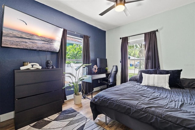 2419 29th Ave E, Palmetto, FL 34221 - bedroom featuring wood finished floors, multiple windows, and ceiling fan