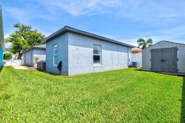 2419 29th Ave E, Palmetto, FL 34221 - view of property exterior featuring stucco siding and a storage shed