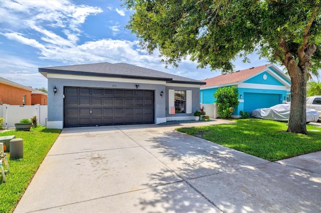2419 29th Ave E, Palmetto, FL 34221 - ranch-style home with stucco siding, concrete driveway, and an attached garage