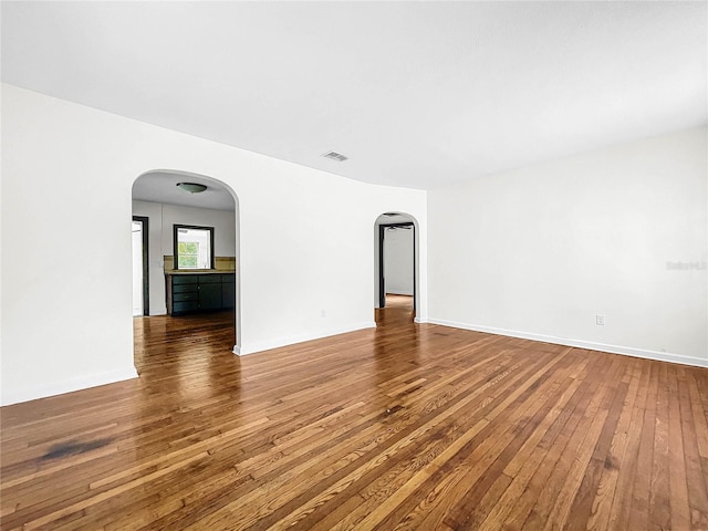 empty room with hardwood / wood-style floors