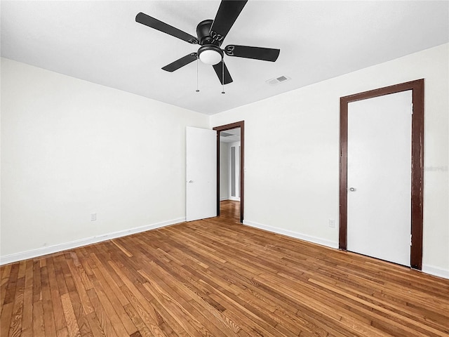 empty room featuring ceiling fan and light hardwood / wood-style floors