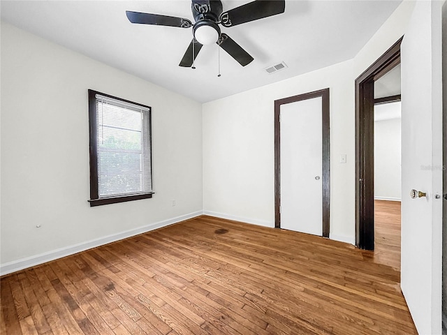 unfurnished bedroom with ceiling fan and wood-type flooring