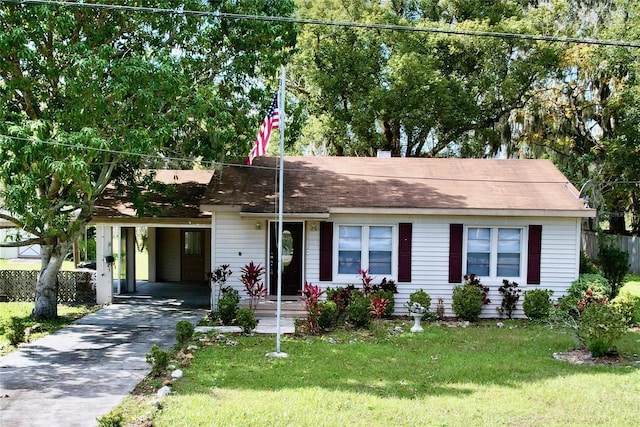 ranch-style house with a front lawn and a carport