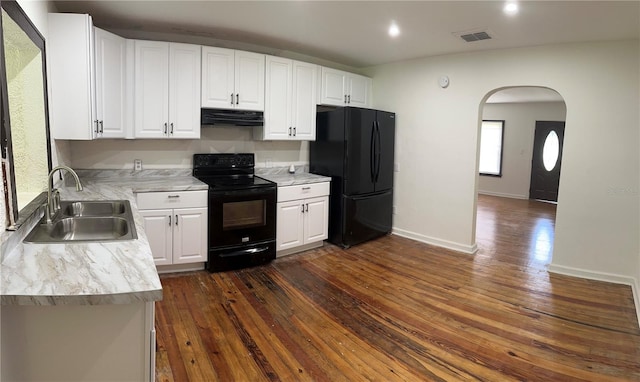 kitchen with black appliances, sink, white cabinets, and dark hardwood / wood-style floors