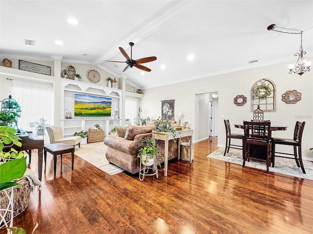 living room featuring lofted ceiling with beams, ornamental molding, ceiling fan with notable chandelier, and hardwood / wood-style flooring