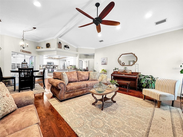 living room with ceiling fan with notable chandelier, ornamental molding, vaulted ceiling with beams, and hardwood / wood-style floors