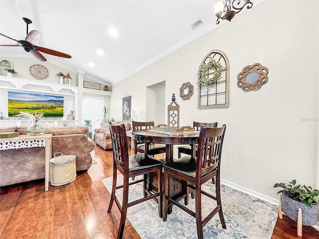 dining space featuring lofted ceiling, ceiling fan, hardwood / wood-style flooring, and ornamental molding