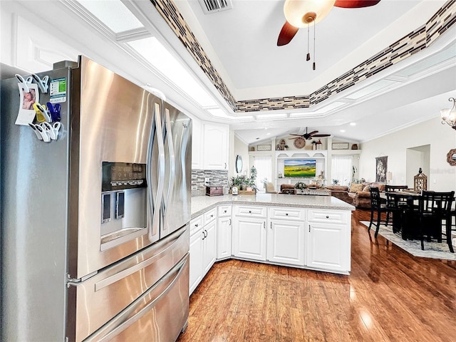 kitchen featuring white cabinets, stainless steel refrigerator with ice dispenser, ceiling fan, and light wood-type flooring