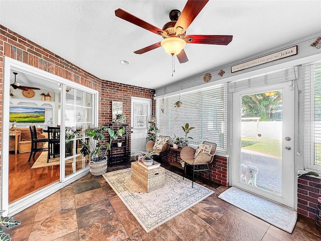 sunroom with ceiling fan