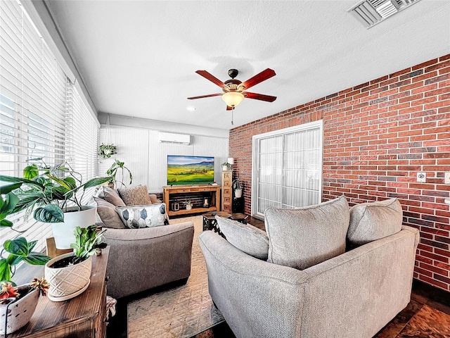 living room with brick wall, plenty of natural light, ceiling fan, and a wall mounted air conditioner