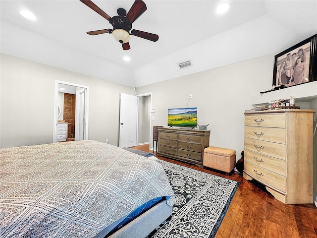 bedroom featuring ceiling fan, ensuite bathroom, and dark hardwood / wood-style floors