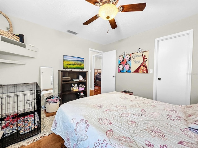 bedroom with ceiling fan and hardwood / wood-style flooring