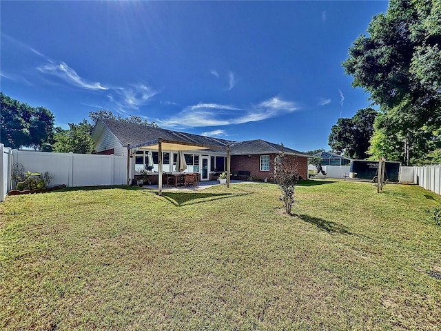 back of house with a lawn and a patio